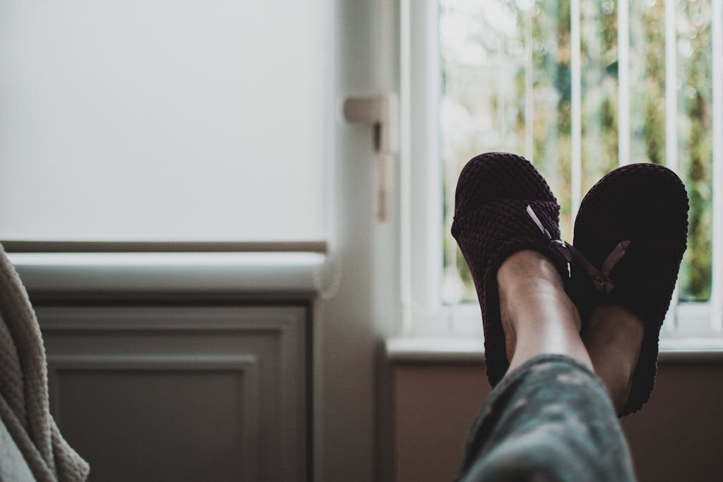 Person Wearing Pair of Black Slides